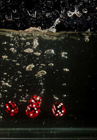 Dice falling into water.の写真素材