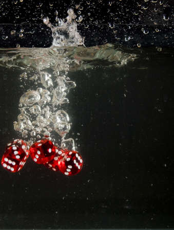 Dice falling into water.の写真素材