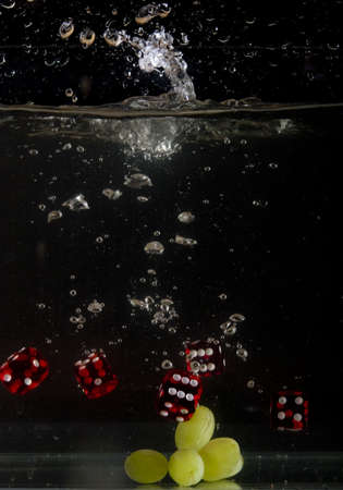 Dice falling into water.の写真素材