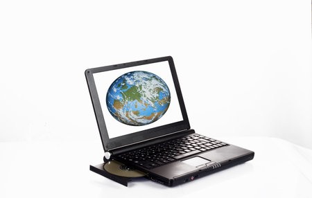 Closeup image from a laptop and a CDRom / DVDRom reader with the Earth