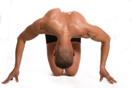 Young sportsman starting on white backgroundの写真素材