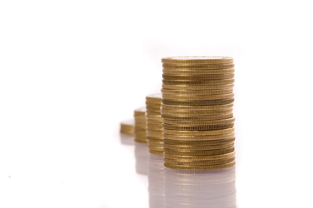 Columns of golden coins isolated on white