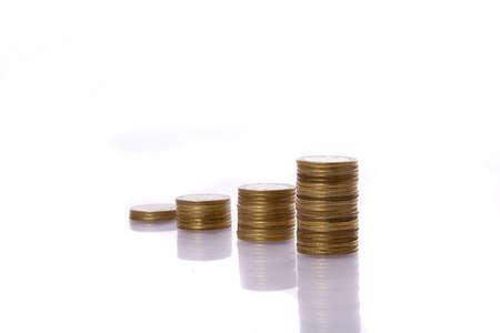 Columns of golden coins isolated on whiteの写真素材