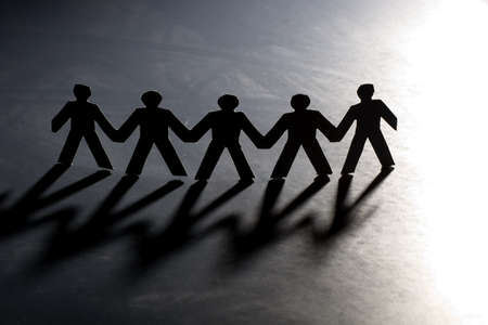 Group of male paper chain representing teamwork.の写真素材