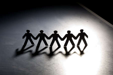 Group of male paper chain representing teamwork.の写真素材