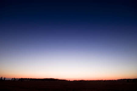 End of day over field with hay baleの写真素材