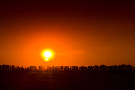End of day over field with hay baleの写真素材