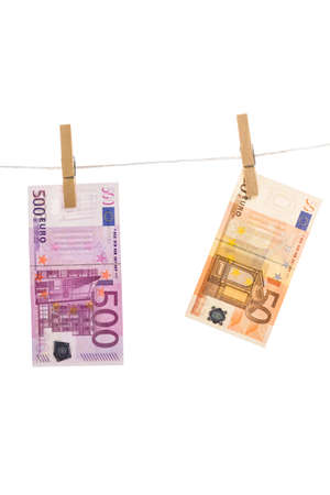 Euro money laundering on clothesline isolated on white backgroundの写真素材