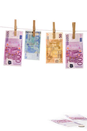 Euro money laundering on clothesline isolated on white backgroundの写真素材