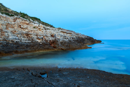Beautiful rocks and sea. Sunrise over the sea near Rt Kamenjak, Croatiaの写真素材