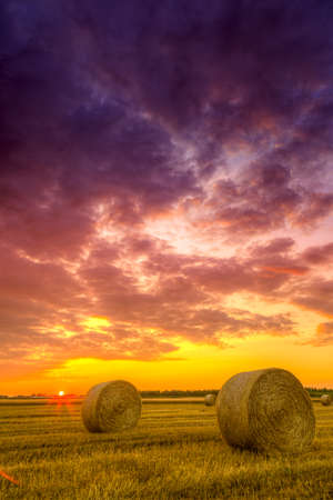 End of day over field with hay bale in Hungary- this photo made by HDR technicの写真素材