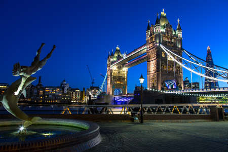 Tower Bridge and St Katharine Docks Girl with a dolpin fountainの写真素材