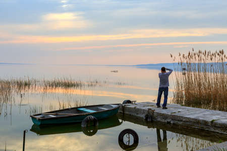 Sunset on the lake Balaton with a boat  in Hungaryの写真素材