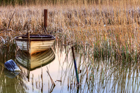 Sunset on the lake Balaton with a boat  in Hungaryの写真素材