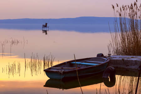 Sunset on the lake Balaton with a boat  in Hungaryの写真素材