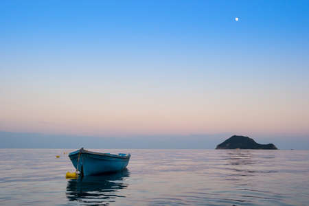 Lonely traditional greek fishing boat on sea water, Zakynthos island, Greeceの写真素材