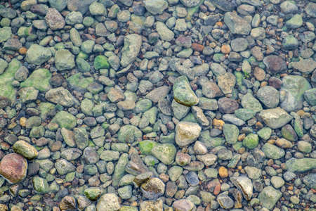 small pebble rock background texture at the beachの写真素材