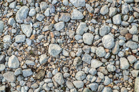 small pebble rock background texture at the beachの写真素材