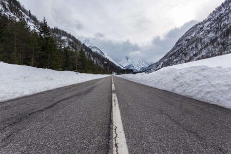 Empty mountain road on a cloudy winter day. Italyの写真素材