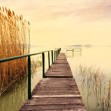 Wooden pier in tranquil lake Balaton-Hungaryの写真素材