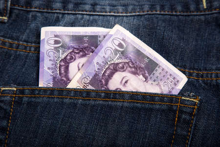 Sterling currency money in the pocket of jeansの写真素材