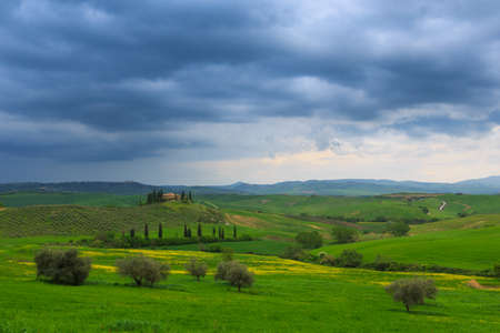 Tuscany landscape at dramatic sky. Typical for the region tuscan farm house, hills,Italyのeditorial素材