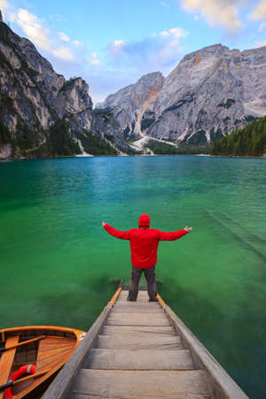 Man alone at the Braies Lake ( Pragser Wildsee ) in Dolomites mountains, Sudtirol, Italyの写真素材