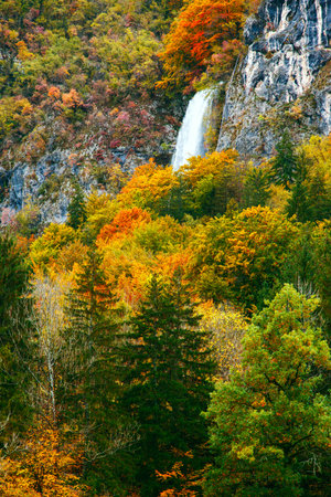 Periodic incredible waterfall in the autumn mountains in Julia Alps. Slovenia
