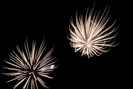 Festive celebration firework lights in the dark night skyの写真素材