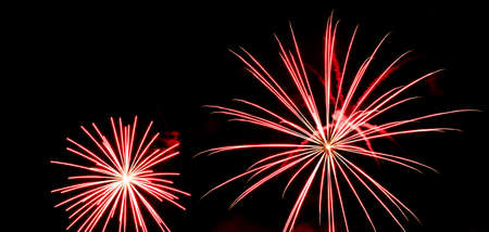 Festive celebration firework lights in the dark night skyの写真素材