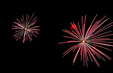 Festive celebration firework lights in the dark night skyの写真素材