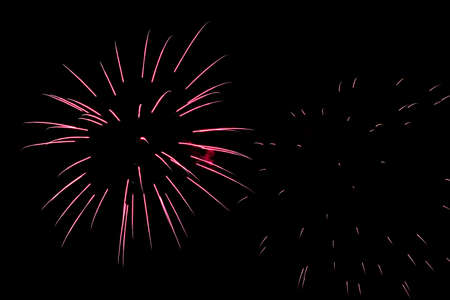 Festive celebration firework lights in the dark night skyの写真素材