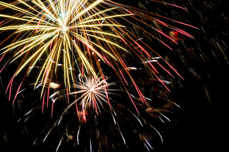 Festive celebration firework lights in the dark night skyの写真素材
