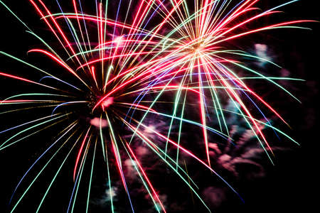 Festive celebration firework lights in the dark night skyの写真素材