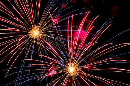 Festive celebration firework lights in the dark night skyの写真素材
