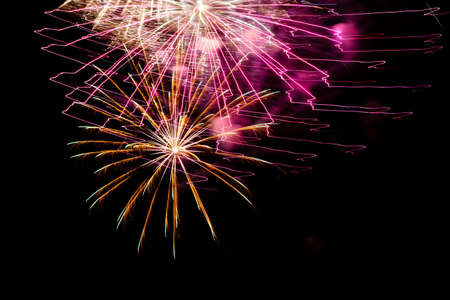 Festive celebration firework lights in the dark night skyの写真素材