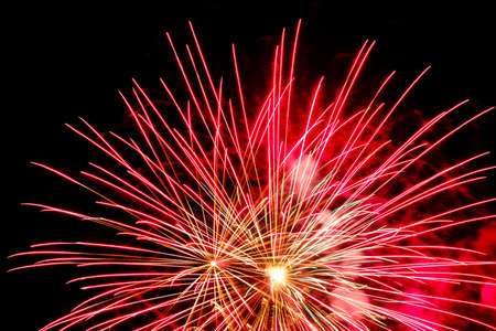 Festive celebration firework lights in the dark night skyの写真素材