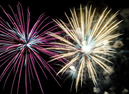 Festive celebration firework lights in the dark night skyの写真素材