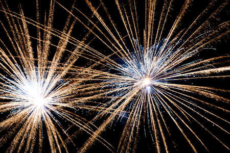 Festive celebration firework lights in the dark night skyの写真素材