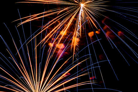 Festive celebration firework lights in the dark night skyの写真素材
