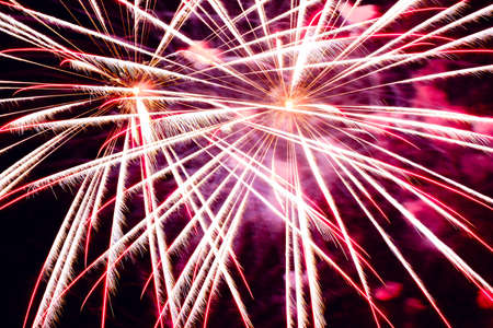 Festive celebration firework lights in the dark night skyの写真素材