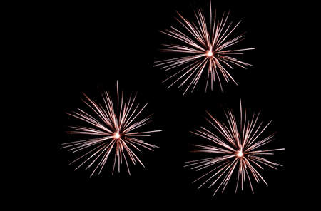 Festive celebration firework lights in the dark night skyの写真素材