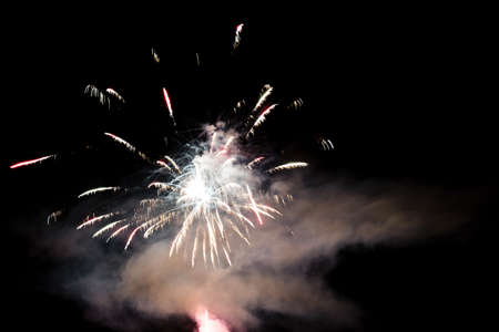 Festive celebration firework lights in the dark night skyの写真素材