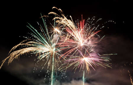 Festive celebration firework lights in the dark night skyの写真素材