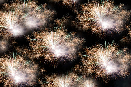 Festive celebration firework lights in the dark night skyの写真素材