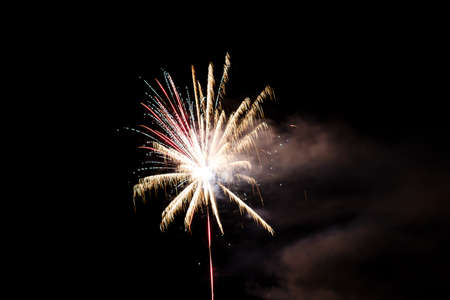 Festive celebration firework lights in the dark night skyの写真素材