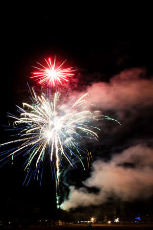 Festive celebration firework lights in the dark night skyの写真素材