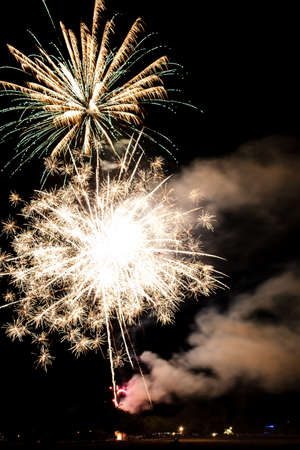 Festive celebration firework lights in the dark night skyの写真素材