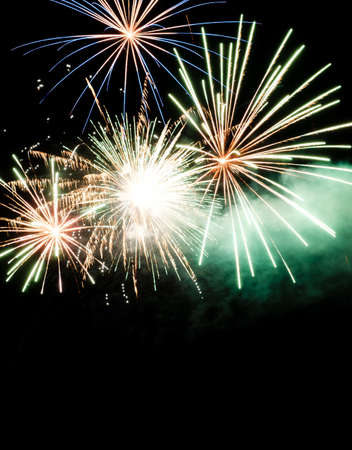 Festive celebration firework lights in the dark night skyの写真素材
