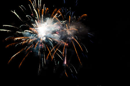 Festive celebration firework lights in the dark night skyの写真素材